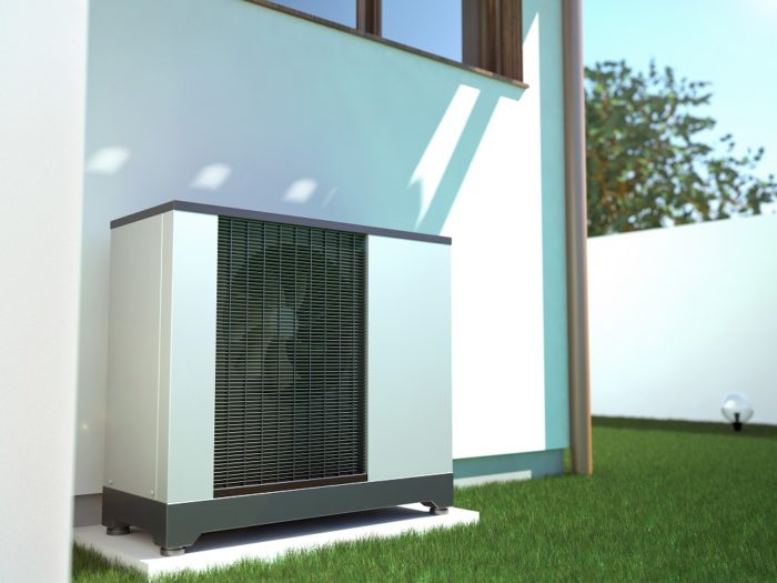 An air source heat pump unit outside a house.