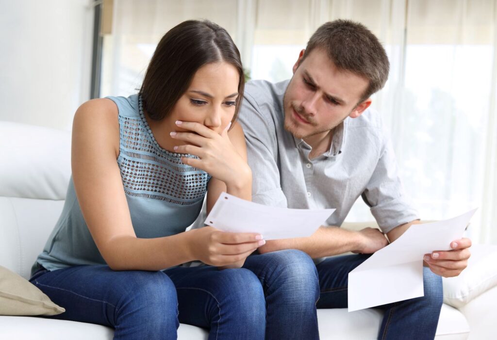 A man and woman looking at their energy bill. They are confused by the Time of Use tariff