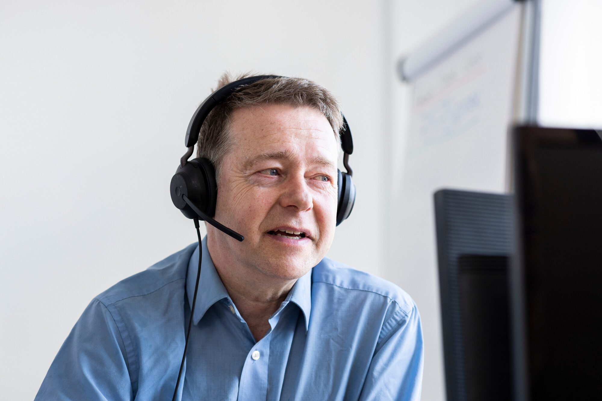 A man talking on a headset.