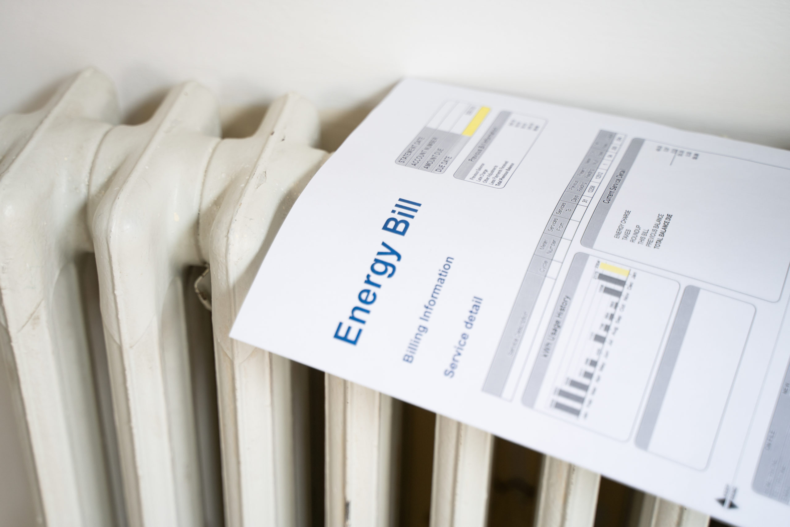 An energy bill lying on top of a radiator