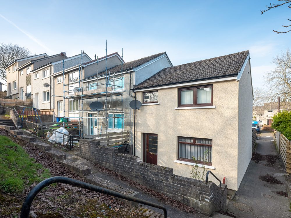 House surrounded by scaffolding having insulation fitted