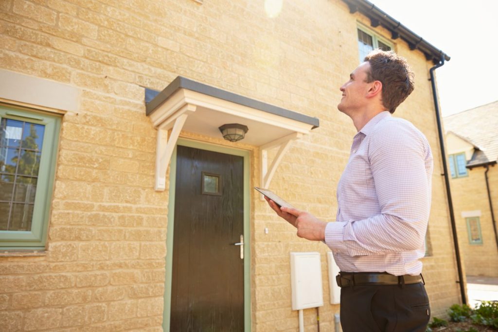 Retrofit assessor outside a house