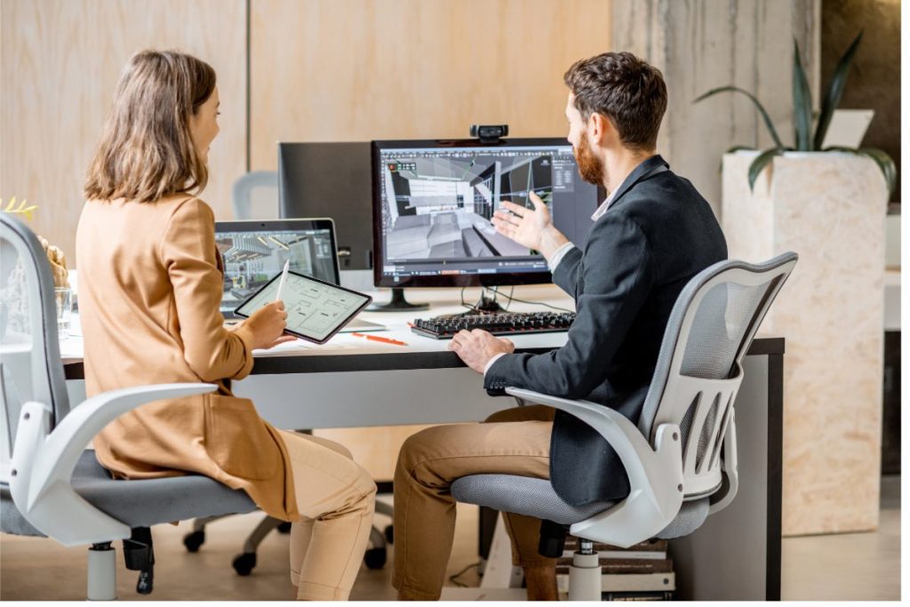 Man and woman working using a computer to model a retrofit