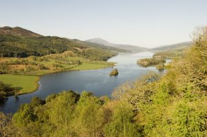 A loch in the Highlands surrounded by trees