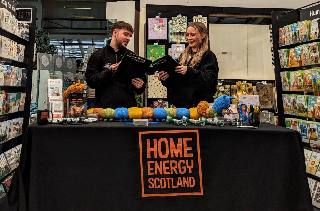 Two home energy scotland advisors behind a stall