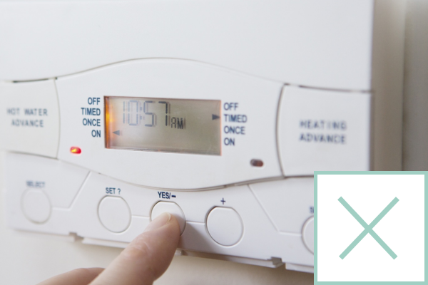 A photo of a heating programmer with a cross in the corner.