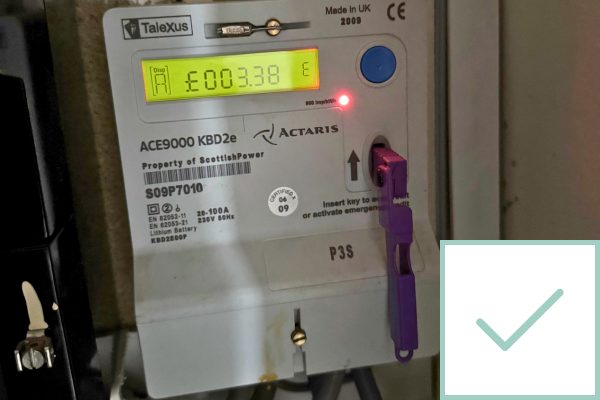 Photo of an electricity prepayment meter with a tick in the corner