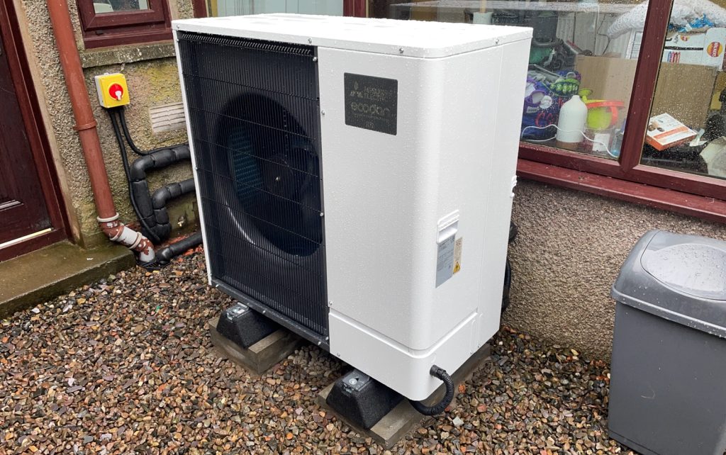 This photo shows a new installed air source heat pump outside a home in the Scottish Borders.