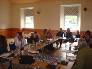 Several people sitting round tables in a room